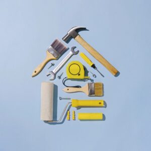 Creative flat lay still life with tools forming a small house